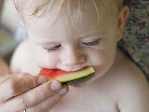 Bebé siendo alimentado con una sandía